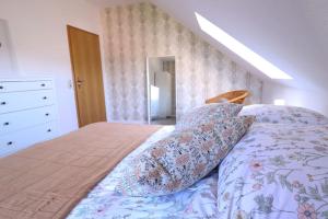 a bedroom with a bed with a floral bedspread at Naturzauber im Harz in Bad Lauterberg