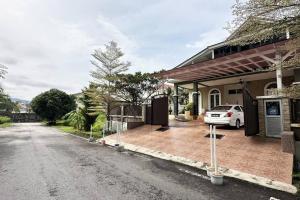 a house with a car parked in the driveway at 21pax KL Event Bungalow in Ampang