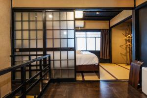 a bedroom with a bed and a staircase in a room at Shiki Homes NATSU in Kyoto