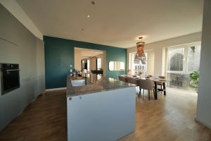 a kitchen and dining room with a counter and a table at Urban retreat loft in the center in Koblenz +31 photos