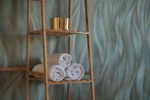 a wooden book shelf with towels on it at Urban retreat loft in the center in Koblenz