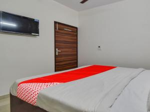 Giường trong phòng chung tại OYO Flagship Hotel Dream Palace