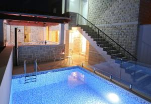 a house with a swimming pool with a staircase at Boutique Hotel Alegria in Supetar