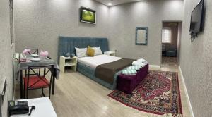 a hotel room with a bed and a table and a tableablish at NRS Hotel in Baku