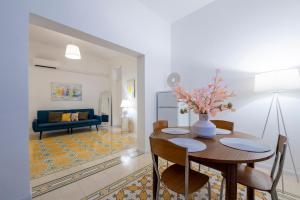 Un comedor y una sala de estar con mesa y sillas. en La Fenice - Mosaic Home, en Trapani