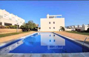 a large swimming pool in front of a building at Wonderful townhouse on Sa Boadella beach in Lloret de Mar