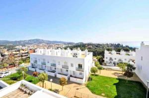 an aerial view of a large white building at Wonderful townhouse on Sa Boadella beach in Lloret de Mar