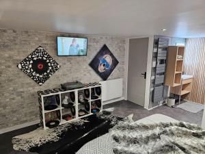 a living room with a wall with a brick wall at Loft 6 couchages (4+2) in Cauterets