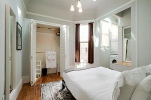 a white bedroom with a bed and a bathroom at Missions Dolores 1br nr dining cafes shops SFO-1621 in San Francisco