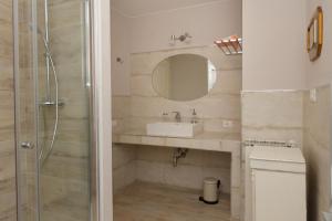 a bathroom with a sink and a shower at Casa Pini Rio_A in Riolunato