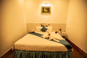Postel nebo postele na pokoji v ubytování Thanh Thanh Spa & Hotel