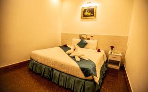 Postel nebo postele na pokoji v ubytování Thanh Thanh Spa & Hotel