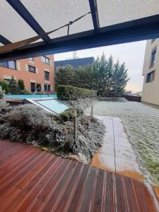 an outdoor deck with a pool in a building at Melrose Apartments in Bratislava