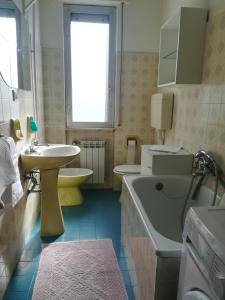 een badkamer met een wastafel, een toilet en een bad bij Residence Villa Carmen fronte mare a 50 mt in Pietra Ligure