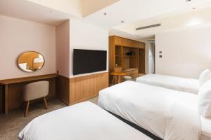 Letto o letti in una camera di Sotetsu Grand Fresa Taipei Ximen