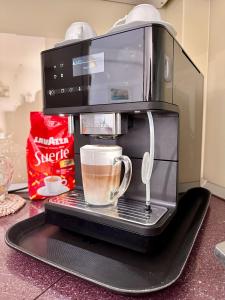 a coffee maker with a cup on a rack at Central Premium Apartment in Braşov