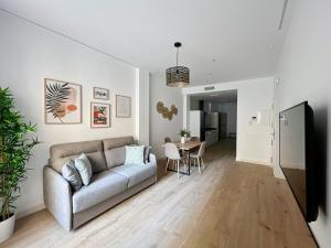 a living room with a couch and a table at Picú Home in Málaga