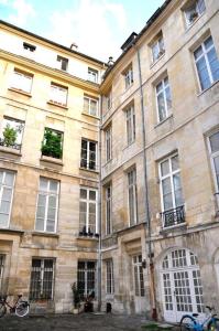 un gran edificio de piedra con ventanas y una bicicleta aparcada delante en Argenson, en París