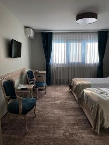 Postel nebo postele na pokoji v ubytování Hotel Coroana