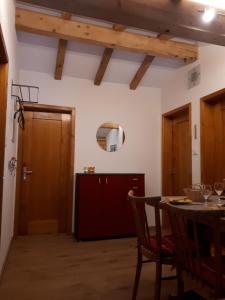 a dining room with a table and a kitchen at Ferienwohnung Tschudiboden in Flumserberg