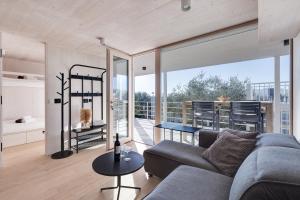 a living room with a couch and a table at Pupsi Garden Villa in Drage