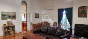 a living room with a couch and a table at The Sunday School Cottage on the Heysen Trail in Burra