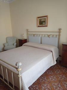 - une chambre avec un lit et une chaise dans l'établissement Melinda House, à Cefalù