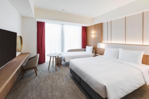 Letto o letti in una camera di Sotetsu Grand Fresa Taipei Ximen