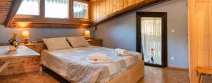 a bedroom with a large bed in a house at B&B La Genzianella in Perarolo di Cadore
