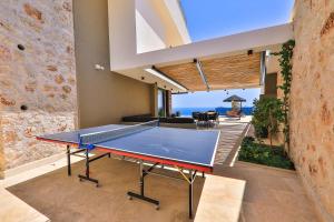 a ping pong table in a living room with the ocean at Villa Eos - Kalkan Villa in Kaş