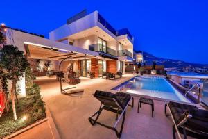 a house with a swimming pool in front of it at Villa Eos - Kalkan Villa in Kaş