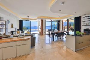 a kitchen and dining room with a view of the ocean at Villa Eos - Kalkan Villa in Kaş