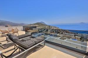 a balcony with chairs and a view of the ocean at Villa Eos - Kalkan Villa in Kaş