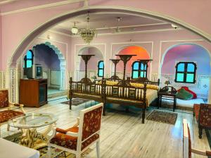 a large room with two beds and a table at Saba Haveli in Jaipur