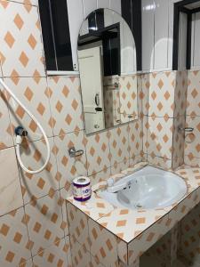 a bathroom with a sink and a mirror at happy trust happy inn in Nuwara Eliya