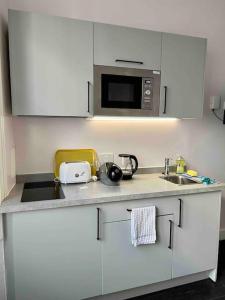 a kitchen with a sink and a microwave at Small studio in Notting Hill in London