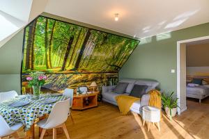 una sala de estar con una pintura de árboles en la pared en L'Aquagîte - Appt avec terrasse vue mer, en Baden