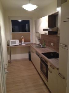 a small kitchen with a sink and a microwave at Apartment Ginsterweg in Hannover