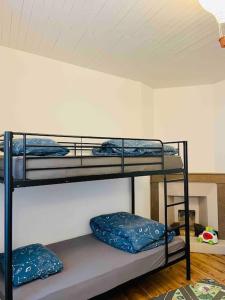 a room with two bunk beds in a room at Agréable maison de village avec balcon in Roiffieux