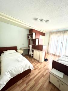una camera con un grande letto, una scrivania e una scrivania di Rolling Apartment Tirana - Near Blloku a Tirana