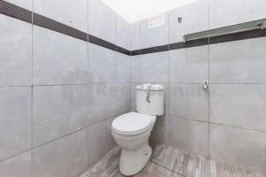 a bathroom with a white toilet in a room at Hotel Linggarjati near Natural Park TWA Linggarjati in Bojong