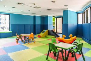 a childrens play room with tables and chairs and a slide at Budget 1BR Apt in Marina - Near Tram & Metro -Time in Dubai