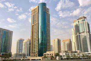 a tall building in the middle of a city at Budget 1BR Apt in Marina - Near Tram & Metro -Time in Dubai