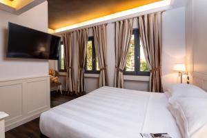 Postel nebo postele na pokoji v ubytování The Glam Boutique Hotel & Apt