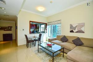 a living room with a couch and a table at Budget 1BR Apt in Marina - Near Tram & Metro -Time in Dubai