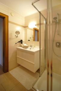 a bathroom with a sink and a shower at Appartementhaus Daniel in Saalbach Hinterglemm
