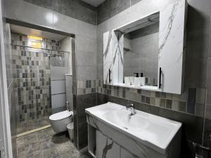 a bathroom with a sink and a toilet at Downtown Inn Madaba in Madaba