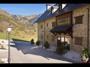 a large stone building with a street light in front of it at PASSARELLS de Alma de Nieve in Gessa