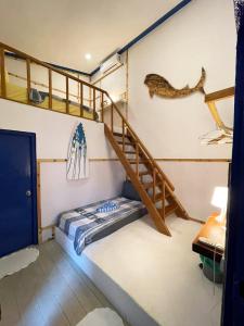 a room with two bunk beds and a staircase at La Due Thulusdhoo in Thulusdhoo