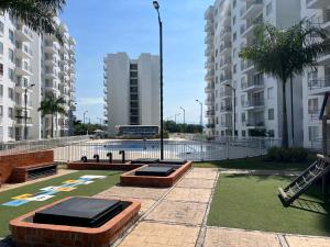 a park with two trampolines in the middle of buildings at Hermoso apartamento para descansar en familia in Girardot